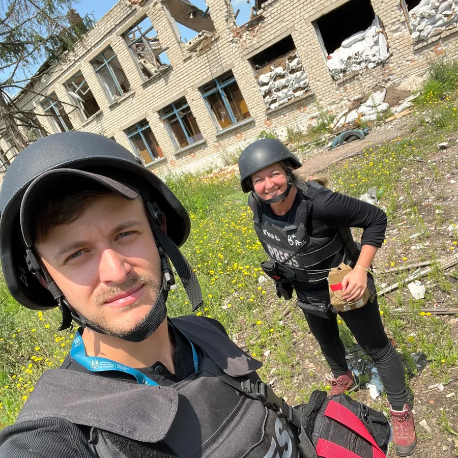 Maxim Strygewski wearing a press vest and helmet in the field